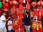 People stand next to a street market stall selling decorations ahead of the Lunar New Year in Jakarta, Indonesia, February 8, 2024. REUTERS/Ajeng Dinar Ulfiana