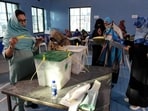 Polling staff opens the ballot boxes in presence of poling agents in Pakistan.(AFP)