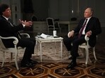  In this pool photograph distributed by Russian state agency Sputnik, Russia's President Vladimir Putin gives an interview to US talk show host Tucker Carlson at the Kremlin in Moscow on February 6, 2024. 