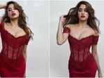 Janhvi Kapoor poses in a red corset maxi dress for a photoshoot. Janhvi Kapoor poses in a red corset maxi dress for a photoshoot.