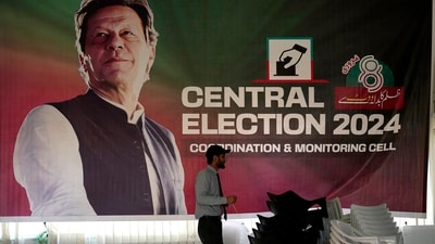 Pakistan Elections 2024: A supporter walks past a poster of imprisoned leader Pakistan's Former Prime Minister Imran Khan display at his party office, in Islamabad, Pakistan. (AP) Pakistan Elections 2024: A supporter walks past a poster of imprisoned leader Pakistan's Former Prime Minister Imran Khan display at his party office, in Islamabad, Pakistan. (AP)