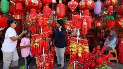 People stand next to a street market stall selling decorations ahead of the Lunar New Year in Jakarta, Indonesia, February 8, 2024. REUTERS/Ajeng Dinar Ulfiana (REUTERS)