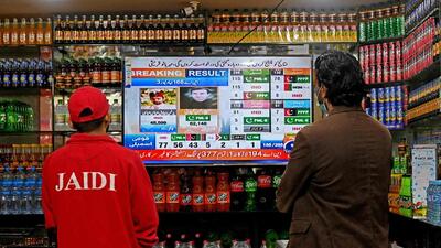 People watch latest election results live on a television at a shop, a day after Pakistan's national elections in Lahore on February 9, 2024. (AFP) People watch latest election results live on a television at a shop, a day after Pakistan's national elections in Lahore on February 9, 2024. (AFP)