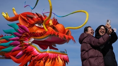 Women take a selfie with a giant dragon lantern decorated near the frozen Houhai Lake in Beijing, Thursday, Feb. 8, 2024. Chinese will celebrate Lunar New Year on Feb. 10 this year which marks the Year of the dragon on the Chinese zodiac. (AP Photo/Andy Wong) (AP) Women take a selfie with a giant dragon lantern decorated near the frozen Houhai Lake in Beijing, Thursday, Feb. 8, 2024. Chinese will celebrate Lunar New Year on Feb. 10 this year which marks the Year of the dragon on the Chinese zodiac. (AP Photo/Andy Wong) (AP)
