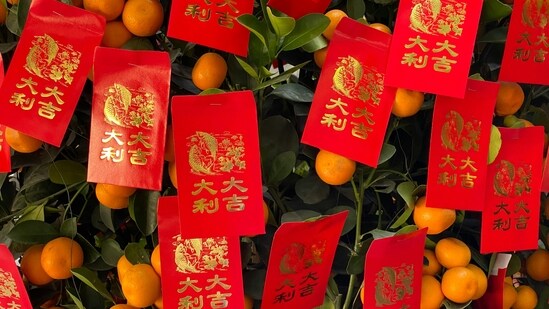 Giving Red Envelopes: Adults give red envelopes (hongbao) containing money to children and unmarried young adults as a symbol of good luck and blessings for the new year. The amount of money is often an auspicious number, such as 8 (representing wealth) or 6 (representing smoothness).(Unsplash)