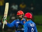 Afghanistan's Mohammad Nabi celebrates with partner Azmatullah Omarzai