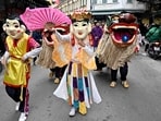 Performers and lion dancers take part in a procession for the upcoming Lunar New Year in Hanoi on January 28, 2024. (Photo by Nhac NGUYEN / AFP)