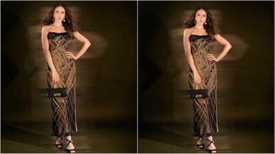 Her glamorous gown, straight from the shelves of ace designer Falguni Shane Peacock, featured an off-the-shoulder neckline in a stunning black fabric with a gold shimmering pattern all over. The bodycon fit perfectly accentuated her gorgeous curves and made her look like a total showstopper. (Instagram/@rakulpreet) Her glamorous gown, straight from the shelves of ace designer Falguni Shane Peacock, featured an off-the-shoulder neckline in a stunning black fabric with a gold shimmering pattern all over. The bodycon fit perfectly accentuated her gorgeous curves and made her look like a total showstopper. (Instagram/@rakulpreet)