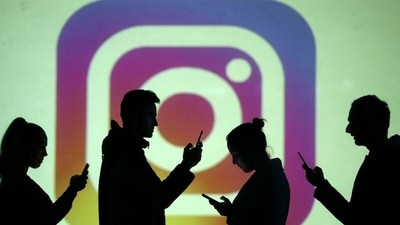 FILE PHOTO: Silhouettes of mobile users are seen next to a screen projection of Instagram logo in this picture illustration taken March 28, 2018. REUTERS/Dado Ruvic/Illustration/File Photo (REUTERS)