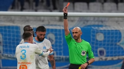 A player could be sent off if they are shown a second blue card. (AP) A player could be sent off if they are shown a second blue card. (AP)