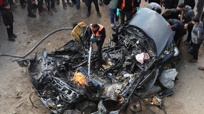 Israel-Hamas War: Palestinians inspect a car hit by an Israeli strike, amid the ongoing conflict between Israel and Hamas, in Rafah. (Reuters)