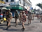 Police officers patrol a road a day after clashes during a government demolition drive, in Haldwani.