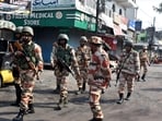 Police officers patrol a road a day after clashes during a government demolition drive in Haldwani.