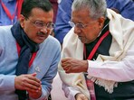 Delhi Chief Minister Arvind Kejriwal interacts with Kerala Chief Minister Pinarayi Vijayan during LDF's protest against the BJP-led Centre over alleged neglect and partiality in allocation of funds to their states, at Jantar Mantar, in New Delhi, (PTI)