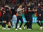 Bayer Leverkusen coach Xabi Alonso celebrates with players after the match 