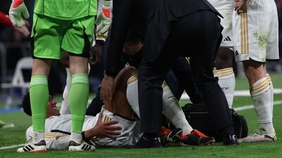 Real Madrid's English midfielder #5 Jude Bellingham (down) receives medical treatment during the Spanish league football match between Real Madrid CF and Girona FC at the Santiago Bernabeu stadium in Madrid on February 10 (AFP)