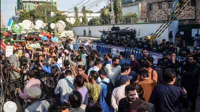 Police (right) stand guard as supporters of the Pakistan Tehreek-e-Insaf (PTI) protest outside an election commission office in Karachi on Saturday, amid claims the election result delay is allowing authorities to rig the vote-counting. (AFP) Police (right) stand guard as supporters of the Pakistan Tehreek-e-Insaf (PTI) protest outside an election commission office in Karachi on Saturday, amid claims the election result delay is allowing authorities to rig the vote-counting. (AFP)