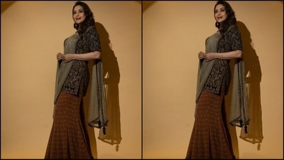 Just a few days ago, Madhuri stunned in another sharara ensemble, featuring a black sweetheart neckline kurta adorned with rich gold floral embroidery. She paired it with a brown printed sharara pant and a green net dupatta adorned with a black mirror work border all over, adding a regal touch to her look. (Instagram/@madhuridixitnene) Just a few days ago, Madhuri stunned in another sharara ensemble, featuring a black sweetheart neckline kurta adorned with rich gold floral embroidery. She paired it with a brown printed sharara pant and a green net dupatta adorned with a black mirror work border all over, adding a regal touch to her look. (Instagram/@madhuridixitnene)