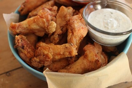 Party chicken wings with cilantro sour cream dip and honey sriracha are displayed in Concord, N.H., on Nov. 16, 2015. Preparing and keeping foods at the right temperature, avoiding cross contamination -- no double dipping! -- and being mindful about leaving out perishable snacks like chicken wings, meatballs and veggie platters are all keys to avoiding illness at your Super Bowl party, health experts said. (AP Photo/Matthew Mead, File) (AP) Party chicken wings with cilantro sour cream dip and honey sriracha are displayed in Concord, N.H., on Nov. 16, 2015. Preparing and keeping foods at the right temperature, avoiding cross contamination -- no double dipping! -- and being mindful about leaving out perishable snacks like chicken wings, meatballs and veggie platters are all keys to avoiding illness at your Super Bowl party, health experts said. (AP Photo/Matthew Mead, File) (AP)