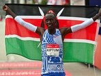 Kelvin Kiptum of Kenya celebrates after setting a new world record time of 2:00:35 at the 2023 Chicago Marathon