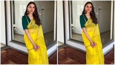 Next but not least on our list is Aditi Rao Hydari. The actress is a total fashionista and her style mantra is simple: keep it casual, comfortable yet trendy. She donned a yellow organza silk saree from Raw Mango. What really elevated her look was the choice of a contrasting blouse in a captivating dark green shade featuring a V-neckline, elbow-length sleeves and gold hand embroidery that added a royal touch to her look. With golden statement jhumka earrings, little back bindi and open hair she rounded off her head turning look. (Instagram/@aditiraohydari) Next but not least on our list is Aditi Rao Hydari. The actress is a total fashionista and her style mantra is simple: keep it casual, comfortable yet trendy. She donned a yellow organza silk saree from Raw Mango. What really elevated her look was the choice of a contrasting blouse in a captivating dark green shade featuring a V-neckline, elbow-length sleeves and gold hand embroidery that added a royal touch to her look. With golden statement jhumka earrings, little back bindi and open hair she rounded off her head turning look. (Instagram/@aditiraohydari)