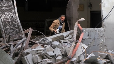 A Palestinian man clears rubble from a damaged building following Israeli airstrikes in Rafah, southern Gaza Strip, on Monday (Bloomberg) A Palestinian man clears rubble from a damaged building following Israeli airstrikes in Rafah, southern Gaza Strip, on Monday (Bloomberg)