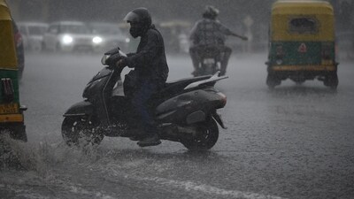 Commuters wading through water-filled roads as rainfall batters Delhi. (HT Photo/Raj K Raj)