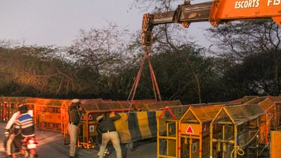 Gurugram: Police personnel get barricades placed at the Delhi-Gurugram border near Sirhaul Toll Plaza ahead of scheduled march by the protesting farmers, in Gurugram, Monday, Feb. 12, 2024. (PTI) Gurugram: Police personnel get barricades placed at the Delhi-Gurugram border near Sirhaul Toll Plaza ahead of scheduled march by the protesting farmers, in Gurugram, Monday, Feb. 12, 2024. (PTI)