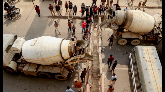 Barricades being put up at Ghazipur border in view of farmers' 'Delhi Chalo March', in New Delhi on Monday. (PTI)