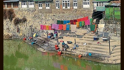 A washerman on banks of Jhelum river on a sunny day in Srinagar on Tuesday. (Waseem Andrabi/HT) A washerman on banks of Jhelum river on a sunny day in Srinagar on Tuesday. (Waseem Andrabi/HT)