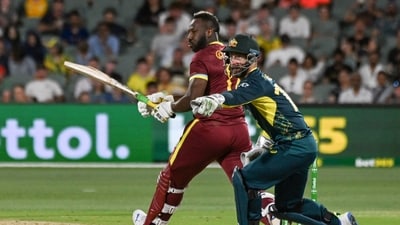 West Indies' Andre Russell plays a shot next to Australia's wicket-keeper Matthew Wade (AFP) West Indies' Andre Russell plays a shot next to Australia's wicket-keeper Matthew Wade (AFP)