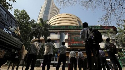 People look at a screen displaying the Sensex results on the facade of the Bombay Stock Exchange (BSE) building in Mumbai. (REUTERS)
