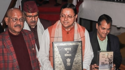 Dehradun: Uttarakhand Chief Minister Pushkar Singh Dhami with others holds a copy of the Constitution of India, at Vidhan Sabha Bhawan, in Dehradun, Tuesday, Feb. 6, 2024. The Uniform Civil Code bill, which proposes uniform marriage, divorce, land, property and inheritance laws for all citizens irrespective of their religion in Uttarakhand, was tabled in the state assembly on Tuesday. (PTI Photo) (PTI02_06_2024_000053A) (PTI) Dehradun: Uttarakhand Chief Minister Pushkar Singh Dhami with others holds a copy of the Constitution of India, at Vidhan Sabha Bhawan, in Dehradun, Tuesday, Feb. 6, 2024. The Uniform Civil Code bill, which proposes uniform marriage, divorce, land, property and inheritance laws for all citizens irrespective of their religion in Uttarakhand, was tabled in the state assembly on Tuesday. (PTI Photo) (PTI02_06_2024_000053A) (PTI)