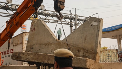 Farmers protest: Cemented barricades being installed near the Tikri border in view of farmers' 'Delhi Chalo' march, near New Delhi, Tuesday. (PTI Photo) (PTI) Farmers protest: Cemented barricades being installed near the Tikri border in view of farmers' 'Delhi Chalo' march, near New Delhi, Tuesday. (PTI Photo) (PTI)