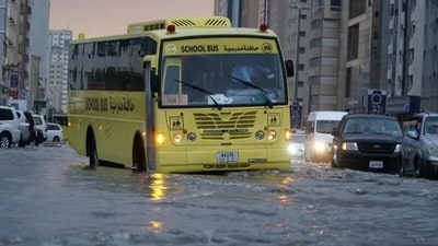A school bus and other vehicle partially submerged as heavy rains batter parts of the UAE. (Al Arabiya News/X) A school bus and other vehicle partially submerged as heavy rains batter parts of the UAE. (Al Arabiya News/X)