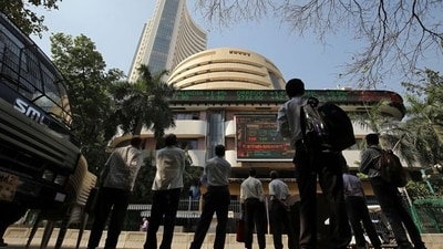 People look at a screen displaying the Sensex results on the facade of the Bombay Stock Exchange (BSE) building in Mumbai. (REUTERS)