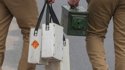 Farmers protest: Police personnel carry tear gas canisters as security has been tightened at Ghazipur border. (PTI) Farmers protest: Police personnel carry tear gas canisters as security has been tightened at Ghazipur border. (PTI)
