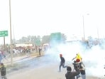 Police use tear gas to disperse protesting farmers gathered at the Punjab-Haryana Shambhu border during the second day of their 'Delhi Chalo' march, near Ambala, Wednesday,