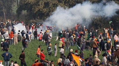 Farmers disperse after police fire teargas shells at them. (AFP) Farmers disperse after police fire teargas shells at them. (AFP)