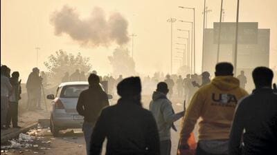 Police using tear gas to disperse protesting farmers gathered at the Punjab-Haryana Shambhu border during the second day of their Dilli Chalo march near Patiala on Wednesday. (PTI Photo)