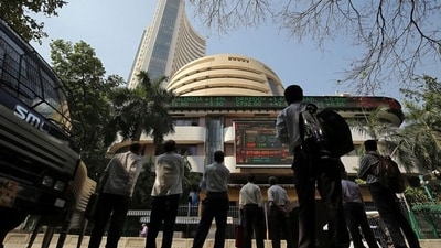 People look at a screen displaying the Sensex results on the facade of the Bombay Stock Exchange (BSE) building in Mumbai. (REUTERS)