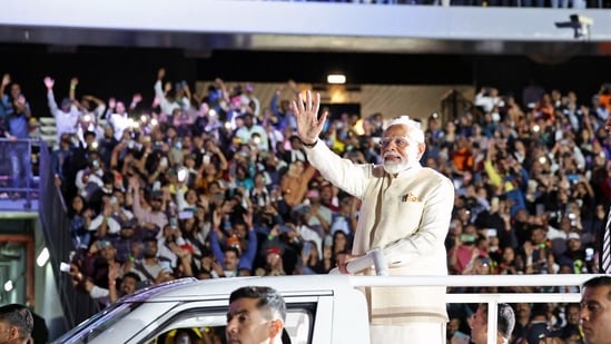 Prime Minister Narendra Modi waves to the people gathered during the 'Ahlan Modi' event at the Zayed Sports Stadium. (ANI)