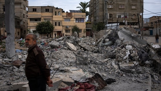 Neighbors inspect the rubble of the Hasouna family house, which was struck by an Israeli airstrike during an operation to rescue two hostages in Rafah, southern Gaza Strip, Tuesday, Feb. 13, 2024. Ibrahim Hasouna, who was away at the time of the airstrike, says his entire family was killed, including his parents, two brothers, his sister-in-law and three nieces and nephews. AP/PTI(AP02_14_2024_000001B) (AP)