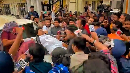 West Bengal Bharatiya Janata Party (BJP) President Sukanta Majumdar falls on the bonnet of a car in North 24 Parganas district on February 14. (PTI)