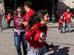 People flee after shots were fired near the Kansas City Chiefs' Super Bowl LVIII victory parade on February 14, 2024, in Kansas City, Missouri.  (Photo by ANDREW CABALLERO-REYNOLDS / AFP)