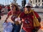 People flee after shots were fired near the Kansas City Chiefs' Super Bowl LVIII victory parade on February 14, 2024, in Kansas City, Missouri. A shooting incident at a packed parade Wednesday to celebrate the Kansas City Chiefs' Super Bowl victory killed one person and injured 21 others, police said. (Photo by ANDREW CABALLERO-REYNOLDS / AFP)