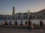 People visit a promenade next to Victoria Harbour in Hong Kong. Travelling to Hong Kong this Spring? Explore coolest art experiences along Victoria Harbour 