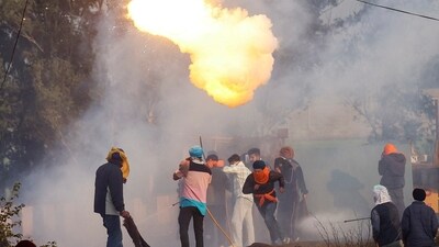 Farmers, marching towards New Delhi to press for better crop prices promised to them in 2021, run for cover as tear gas is fired by police to disperse them, at Shambhu, a border crossing between Punjab and Haryana. (Reuters)
