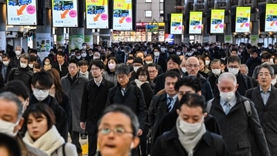 Commuters walk through Shinagawa Station during the morning rush hour in Tokyo. (AFP) Commuters walk through Shinagawa Station during the morning rush hour in Tokyo. (AFP)