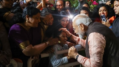 PM Modi greeted people who had gathered outside his hotel in Doha to welcome him, shaking hands with them. Some even presented him with gifts like books, and people took pictures as he interacted with them. (PTI) PM Modi greeted people who had gathered outside his hotel in Doha to welcome him, shaking hands with them. Some even presented him with gifts like books, and people took pictures as he interacted with them. (PTI)